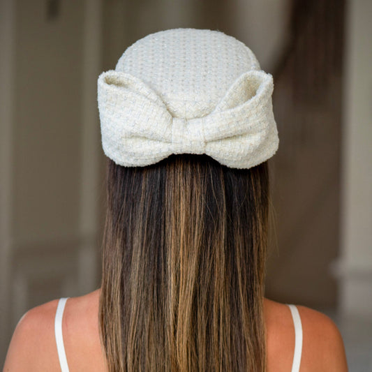 Person wearing a textured white headband with long hair.